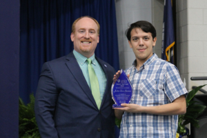 Administrator presenting award to student