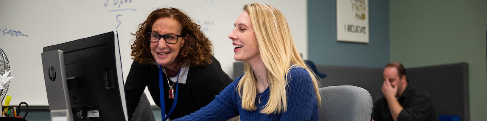 Staff member assisting student