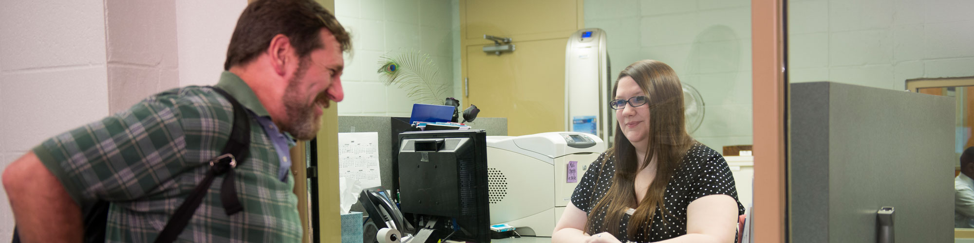 Student at the cashier's window at Aiken Technical College