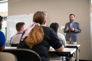 Instructor teaching at the front of a class