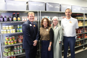 Four professionals standing in the food pantry